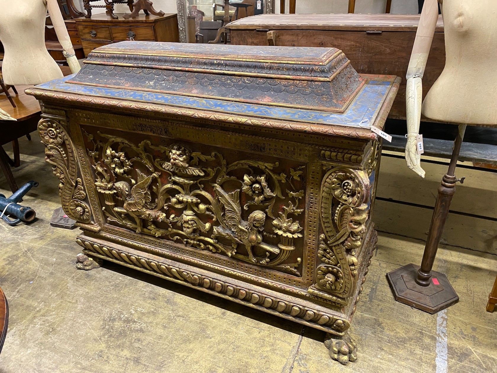A 17th century style painted gilded cassone on lion's paw feet, length 153cm, depth 66cm, height 118cm